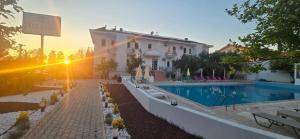 a house with a swimming pool in front of a building at Bena pansiyon in Fethiye