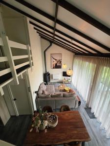 a living room with a couch and a table at Slow Stay Coo in Stavelot