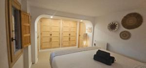 a bedroom with a bed with a black bag on it at Villa Mirella in Jávea