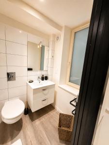 a bathroom with a white toilet and a sink at L'Instant Saint-Epvre Charm & Old Town in Nancy