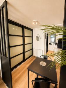 a room with a table and chairs and a bedroom at L'Instant Saint-Epvre Charm & Old Town in Nancy