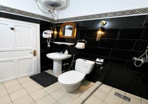 a bathroom with a white toilet and a sink at Dar Albanin in Fez +41 photos