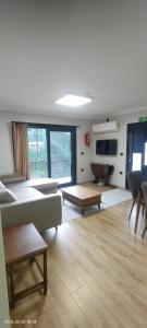a living room with a couch and a table at LEYLİ GABAN VİLLA in Çaykara
