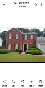 two pictures of a red brick house at Nijsha Enterprise in Jonesboro