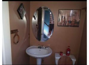 a bathroom with a sink and a mirror on the wall at Nijsha Enterprise in Jonesboro +9 photos