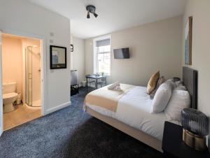 a hotel room with a bed and a bathroom at The Marlowe in Southport