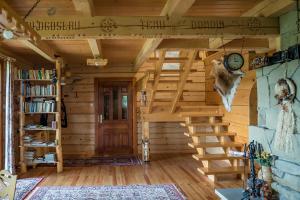 a room with a wooden staircase and a clock on the wall at Jaworówka na Polnej in Nowy Targ