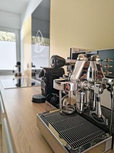 a coffee maker sitting on top of a kitchen counter at Eifelloft&Spa in Adenau