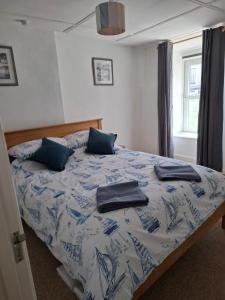 a bedroom with a bed with two pillows on it at 17 French Street in Teignmouth