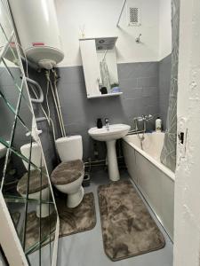 a bathroom with a sink and a toilet and a sink at Mykolaichuka in Chernivtsi