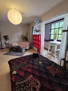 a bedroom with a bed and a living room at Modern & Quiet City Apartment in Hannover