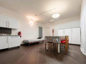 a kitchen with a table and chairs in a room at Ground floor house in Castel Bolognese