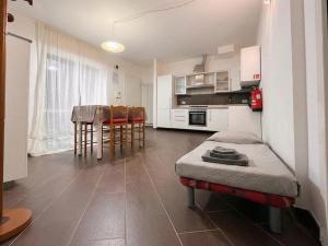 a room with a kitchen and a table and chairs at Ground floor house in Castel Bolognese +6 photos