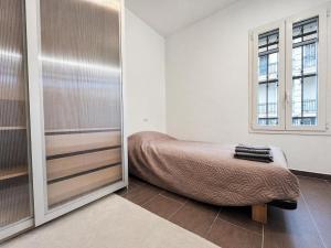 a small bedroom with a bed and a mirror at Ground floor house in Castel Bolognese