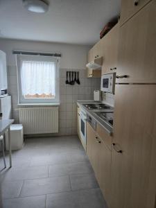 a small kitchen with a stove and a window at Ferienhaus Parnet in Neudorf +10 photos