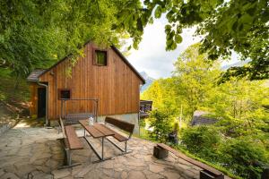 a wooden barn with a bench in front of it at Chata Zuzana in Terchová
