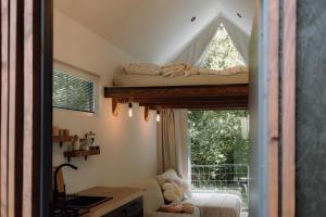a bedroom with a bed in a window at Lesná Obývačka in Stará Huta