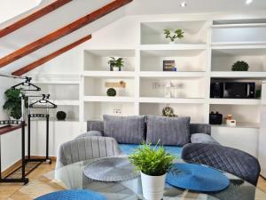 a living room with a couch and a glass table at Apartments Sandra in the historical center of the city in Supetar