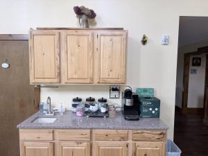 a kitchen with wooden cabinets and a counter top at The Old Lantern Inn in Charlotte +24 photos