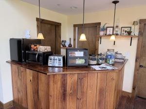 a kitchen with a counter with a microwave on it at The Old Lantern Inn in Charlotte