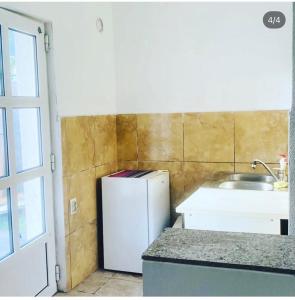 a kitchen with a white refrigerator and a sink at Apartmani Ljilja in Zgrada