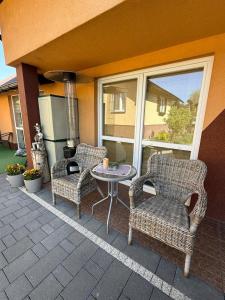 two chairs and a table on a patio at Sosnowe Zacisze in Zwierzyniec