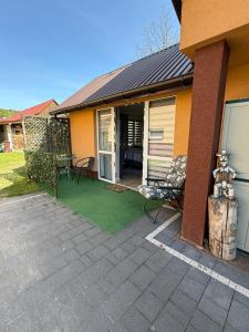 a house with a patio with a green lawn at Sosnowe Zacisze in Zwierzyniec +13 photos