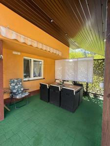 an outdoor patio with a chair and a table at Sosnowe Zacisze in Zwierzyniec