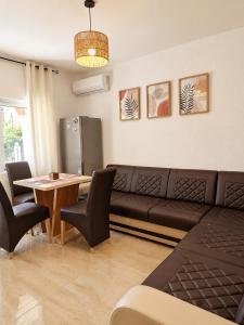 a living room with a couch and a table at Monte Liza Apartments in Dobra Voda