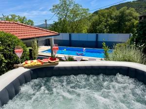 a swimming pool with a water feature in a backyard at Kameni dvori - Family Villa with Pool & Jacuzzi for 8 in Imotski
