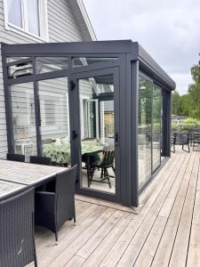 a screened in porch with a table on a deck at The Cheerful Villa In Perstorp in Perstorp
