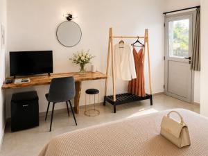 a bedroom with a desk with a bed and a mirror at Maxa Residences - Free Airport Shuttle in Artemida