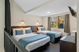 a hotel room with two beds and a window at Ashford Motor Lodge in Christchurch +23 photos