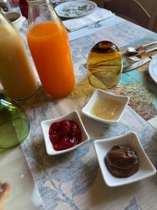 a table with plates of food and a glass of orange juice at Villa Fontana 2 in Capannori +3 photos