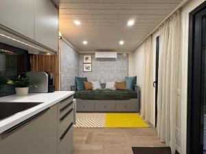 a kitchen with a bed with a yellow rug at MetsaMaja in Hiiumaa