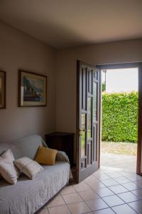 a room with a bed and a sliding glass door at Alveare 27 in Monticelli Brusati