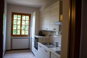 a kitchen with a sink and a stove at Alveare 27 in Monticelli Brusati