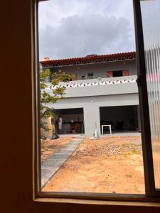a view of a white building from a window at Casa cidade Pedro II PI in Pedro II