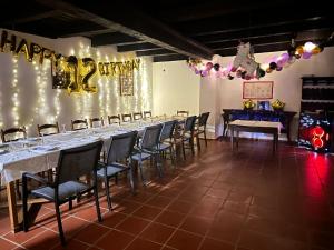 a party hall with a long table with a happy anniversary sign at Rusticca M- slavonska kuća in Rokovci