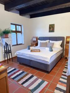 a bedroom with a large bed in a room at Rusticca M- slavonska kuća in Rokovci