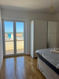 a bedroom with a bed and a large sliding glass door at Four bedroom Beach House Amaya Medulin in Medulin +116 photos