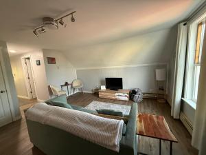 a living room with a couch and a table at The Downtown Loft in Fairbanks