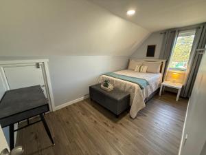 a small bedroom with a bed and a window at The Downtown Loft in Fairbanks
