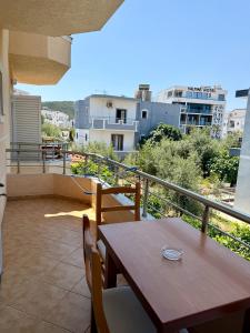 a table and chairs on a balcony with a view at Mihasi Apartments in Ksamil +30 photos
