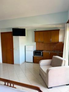 a living room with a couch and a kitchen at Mihasi Apartments in Ksamil