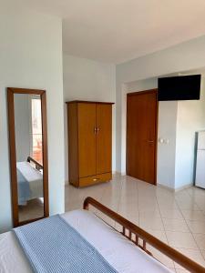 a bedroom with a bed and a mirror at Mihasi Apartments in Ksamil