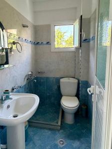 a bathroom with a toilet and a sink at Mihasi Apartments in Ksamil