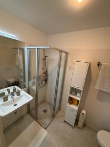 a bathroom with a shower and a sink at Cozy Apartment in Graz +25 photos