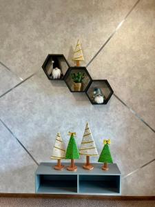 a display of christmas decorations with trees on a table at Котедж Villagoria з теплим басейном in Slavske