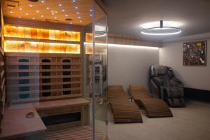 a room with two chairs and a glass elevator at Veloralux Apartman in Kovácsszénája